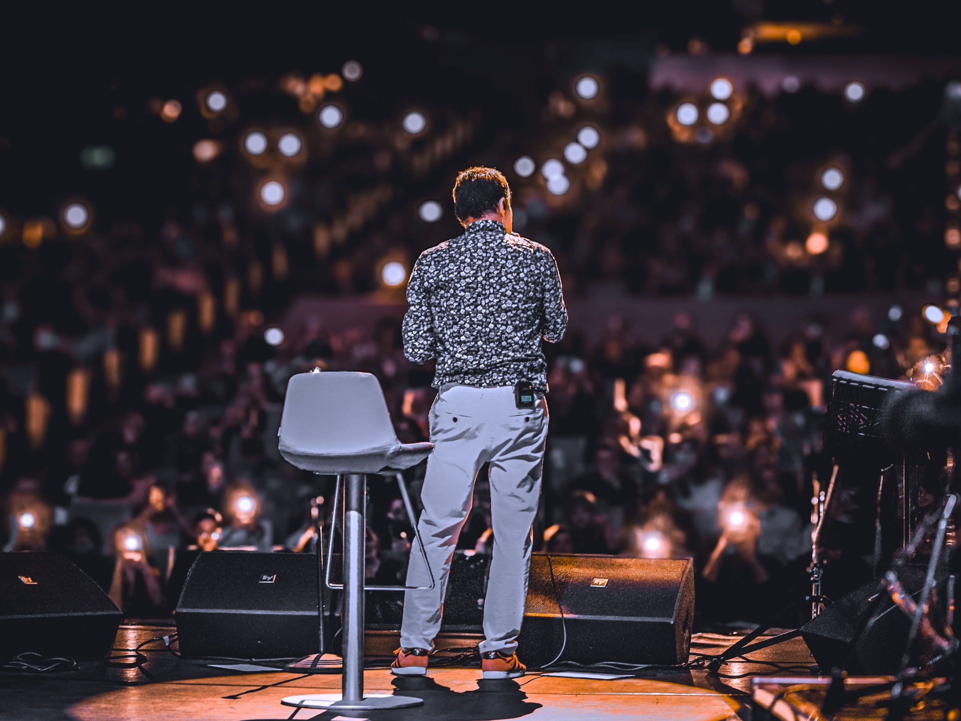 Expert speaking on stage to a live audience